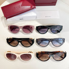 Set of Gucci cat-eye sunglasses in purple, black, and cream with gradient lenses