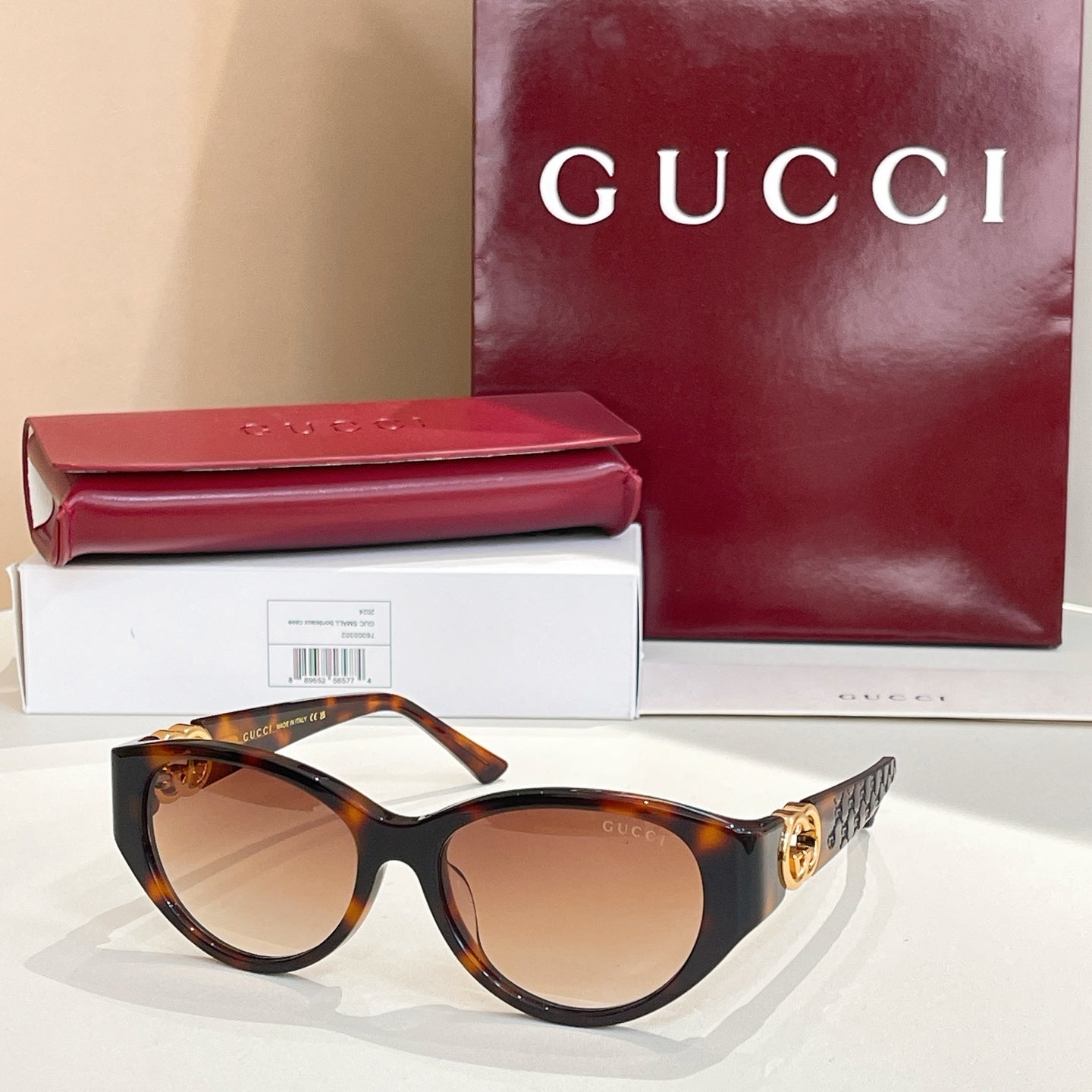 Gucci cat-eye sunglasses with dark tortoise frames and warm brown lenses