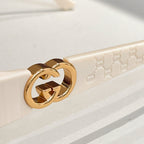 Gucci gold GG emblem on sunglasses temple with light frame