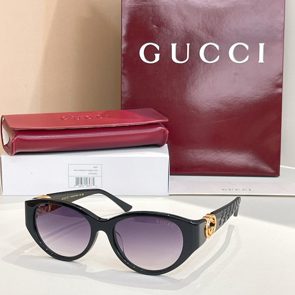 Gucci cat-eye sunglasses with black frames and purple-tinted lenses