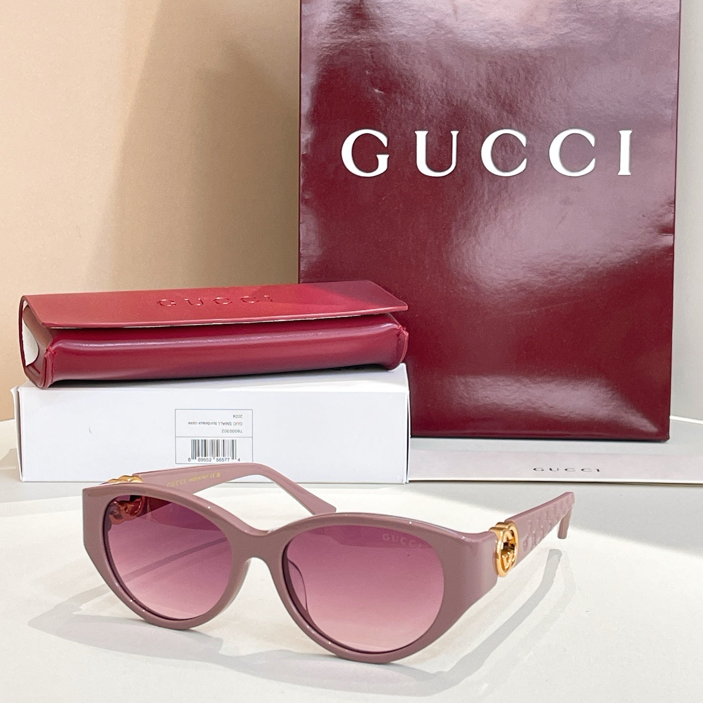 Gucci cat-eye sunglasses with light pink frames and pink-tinted lenses