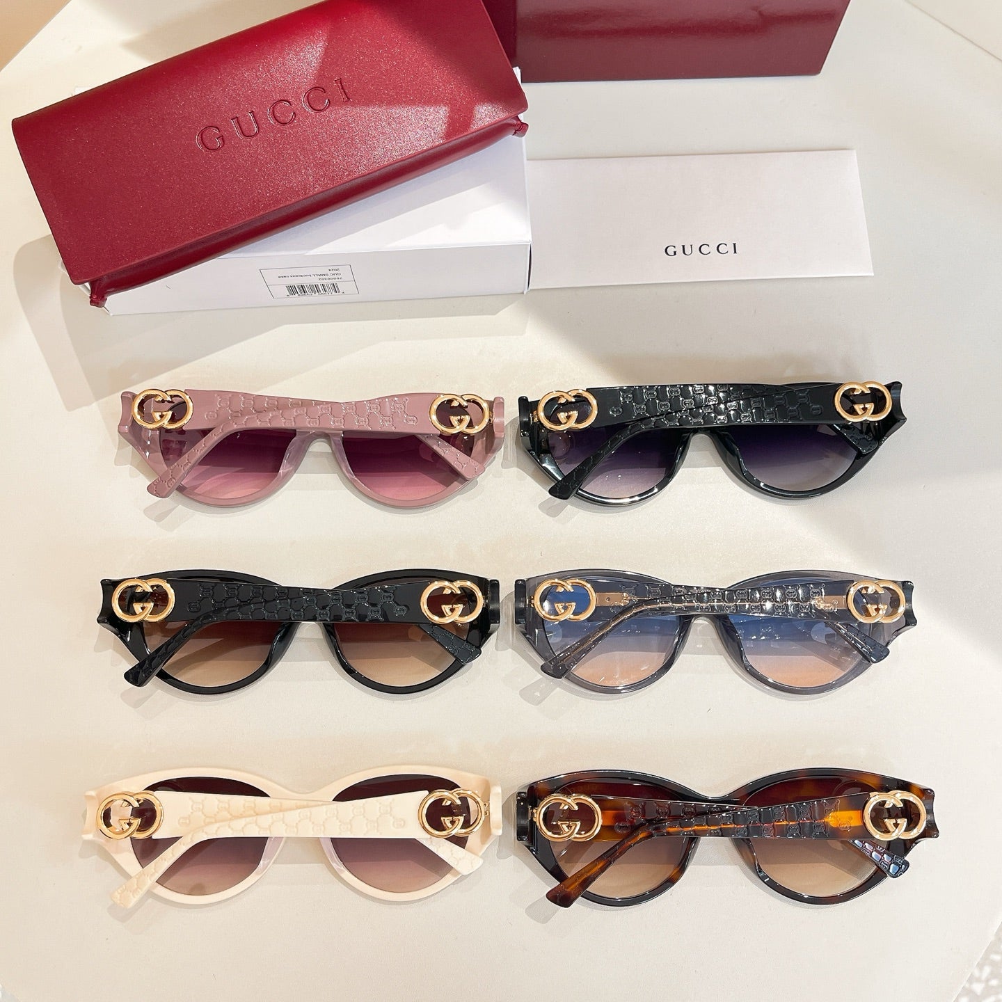 Assorted Gucci sunglasses with GG hardware: pink, black, and tortoise frames