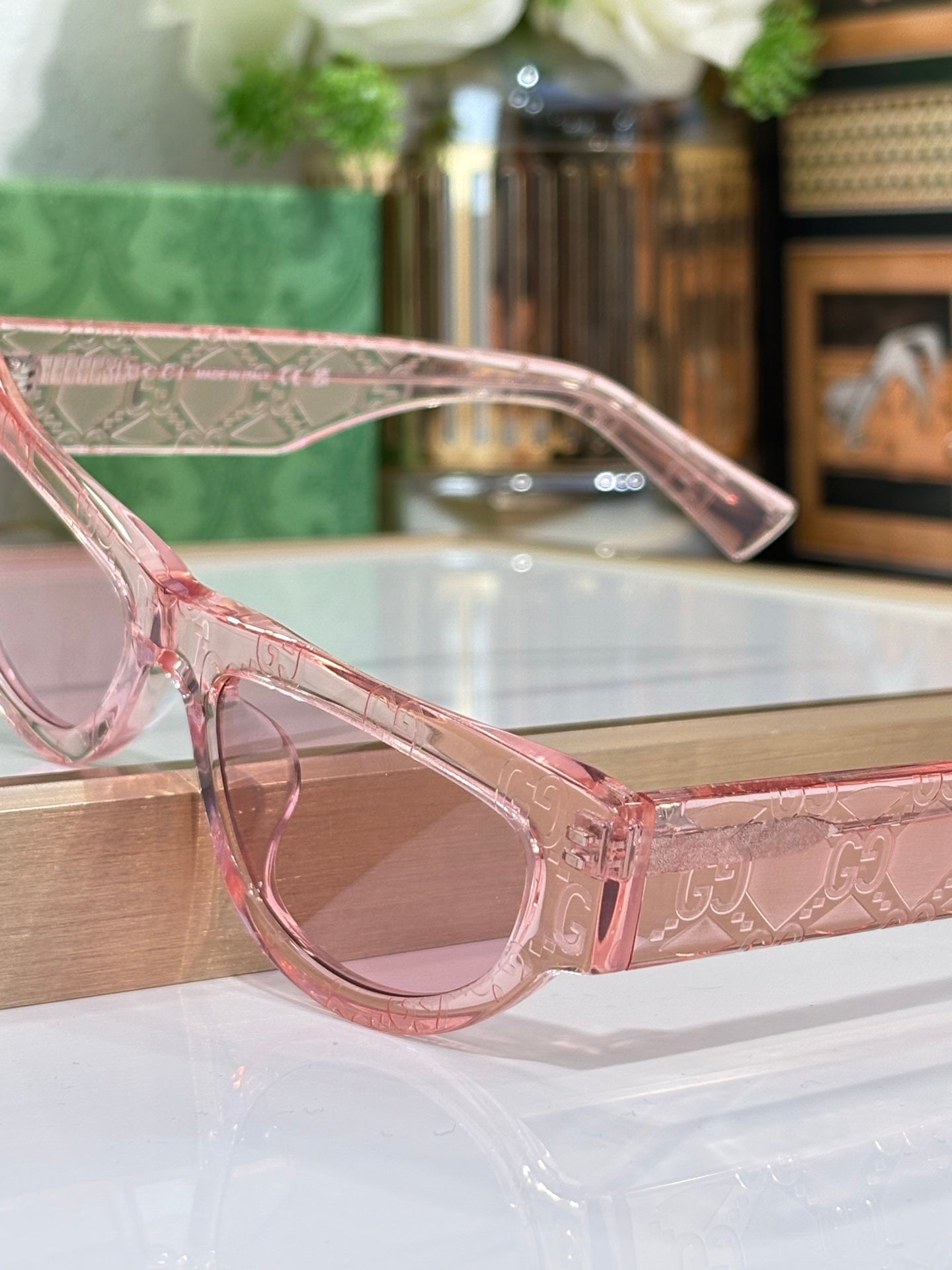 Pink transparent glasses frames with tinted lenses, side view