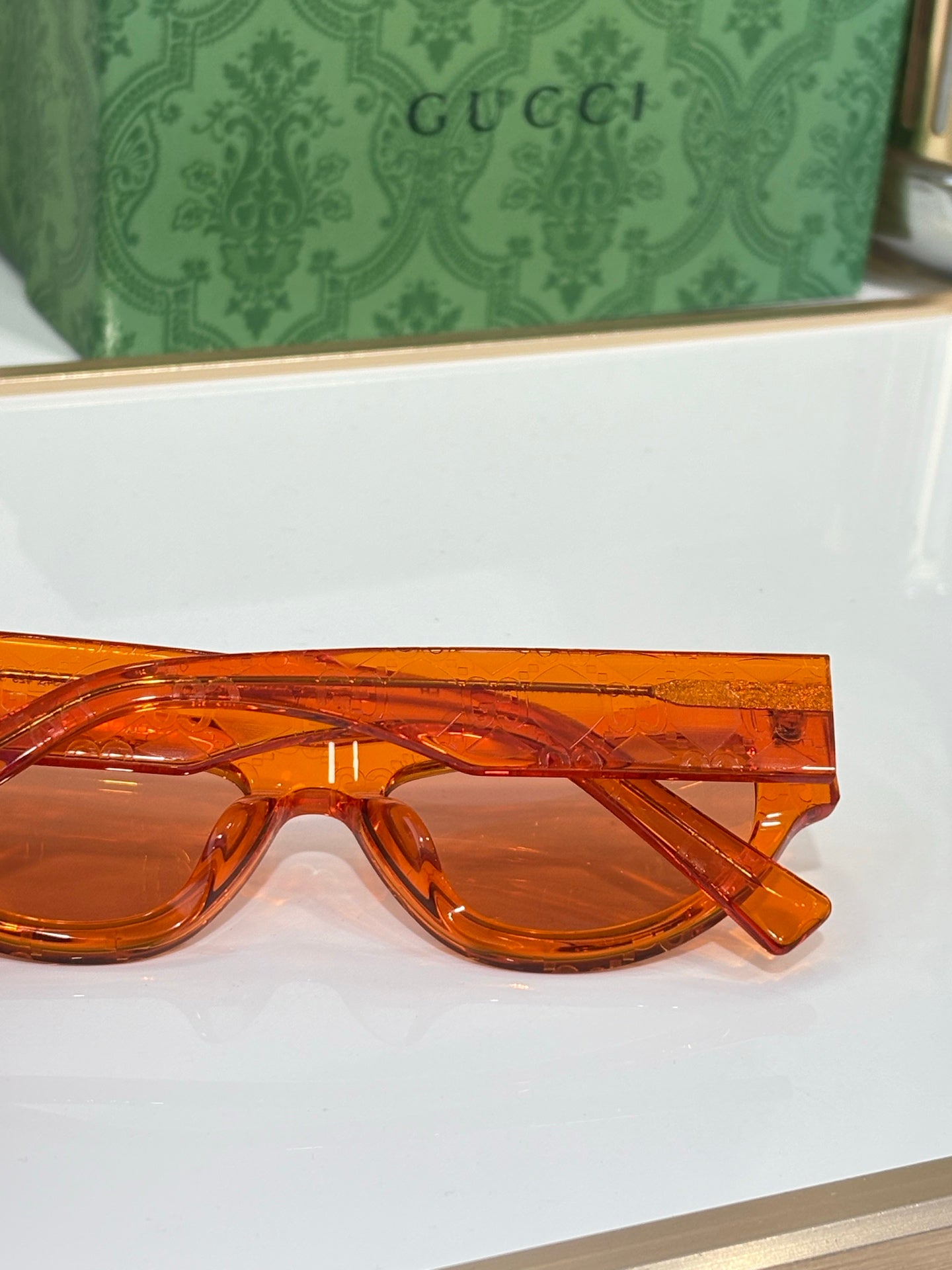 Close-up of orange glasses frames with tinted lenses