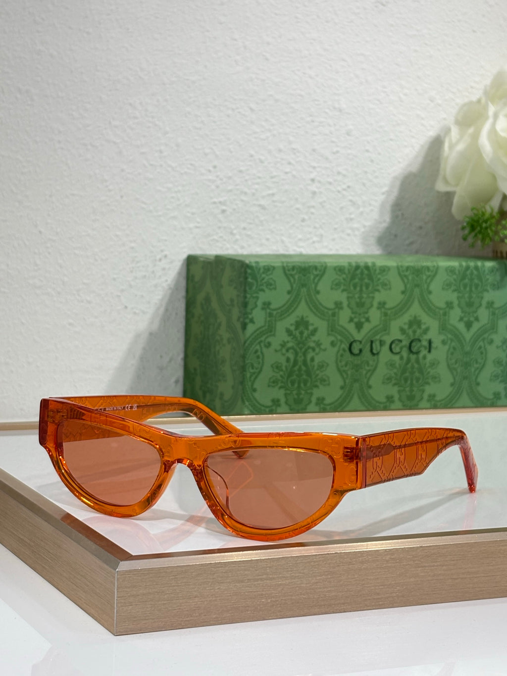 Glasses with orange-brown frames and tinted lenses