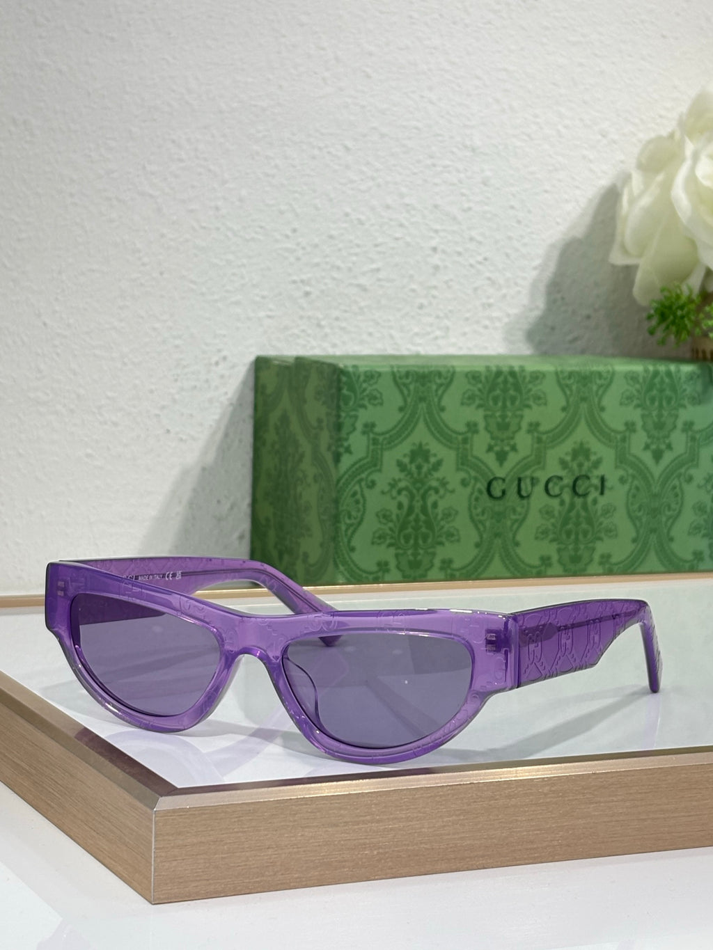 Glasses with purple frames and dark tinted lenses