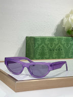 Glasses with purple frames and dark tinted lenses