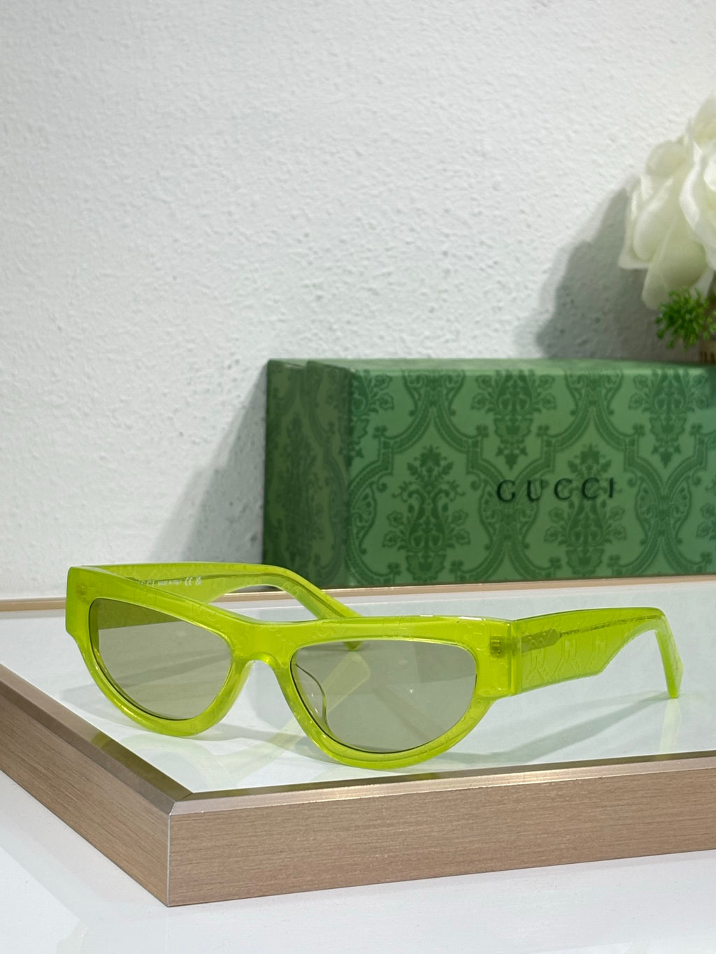 Gucci glasses with neon yellow-green frames and tinted lenses