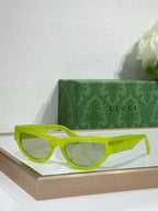 Gucci glasses with neon yellow-green frames and tinted lenses