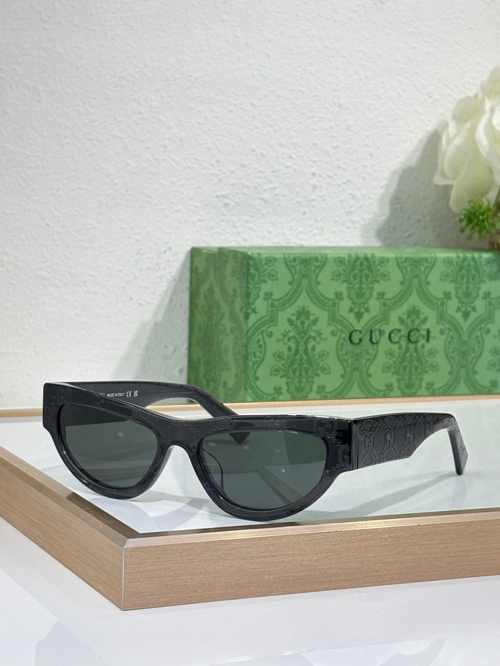 Glasses with black frames and dark tinted lenses