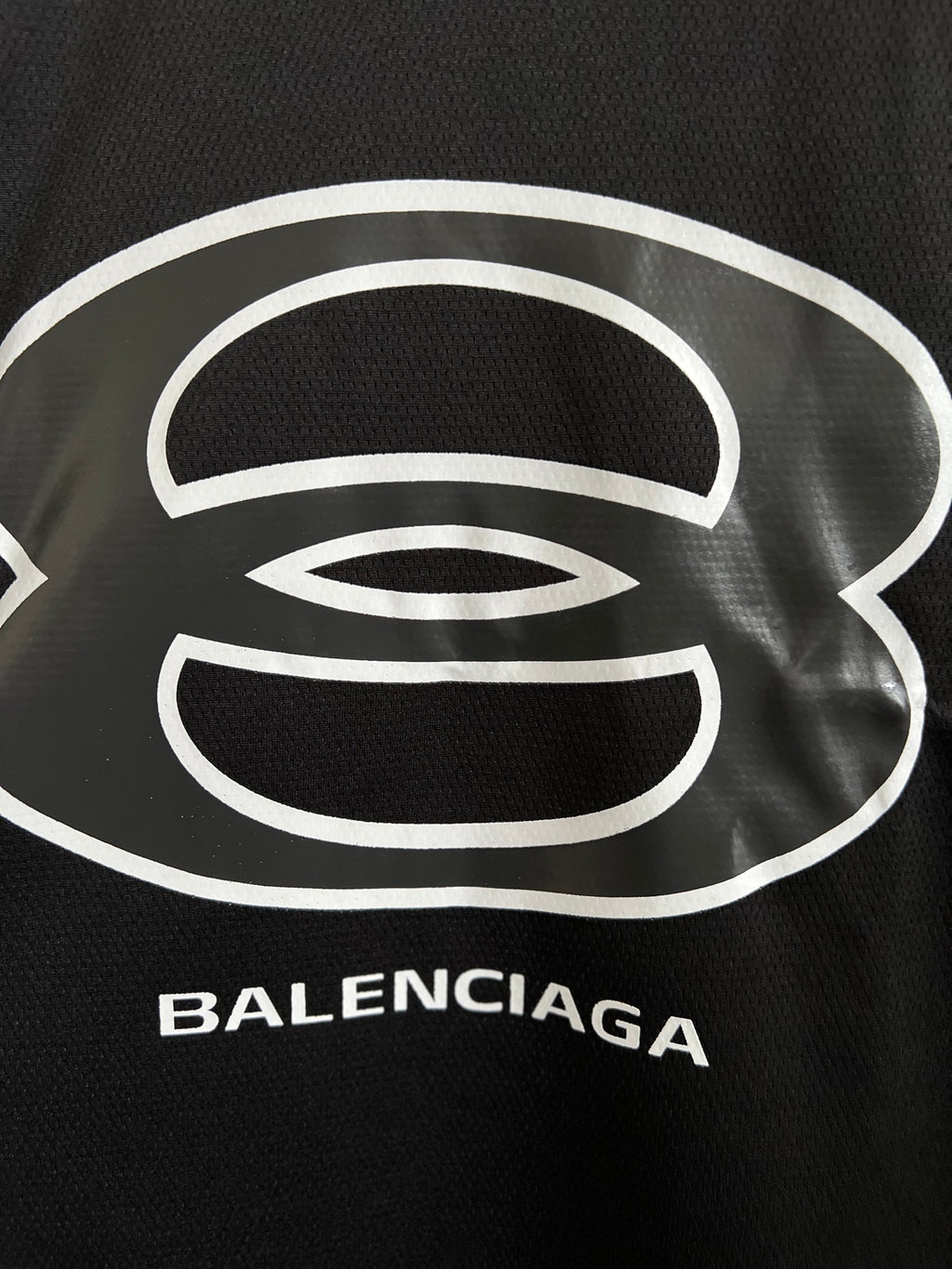 Balenciaga black T-shirt close-up of white logo print and BALENCIAGA text