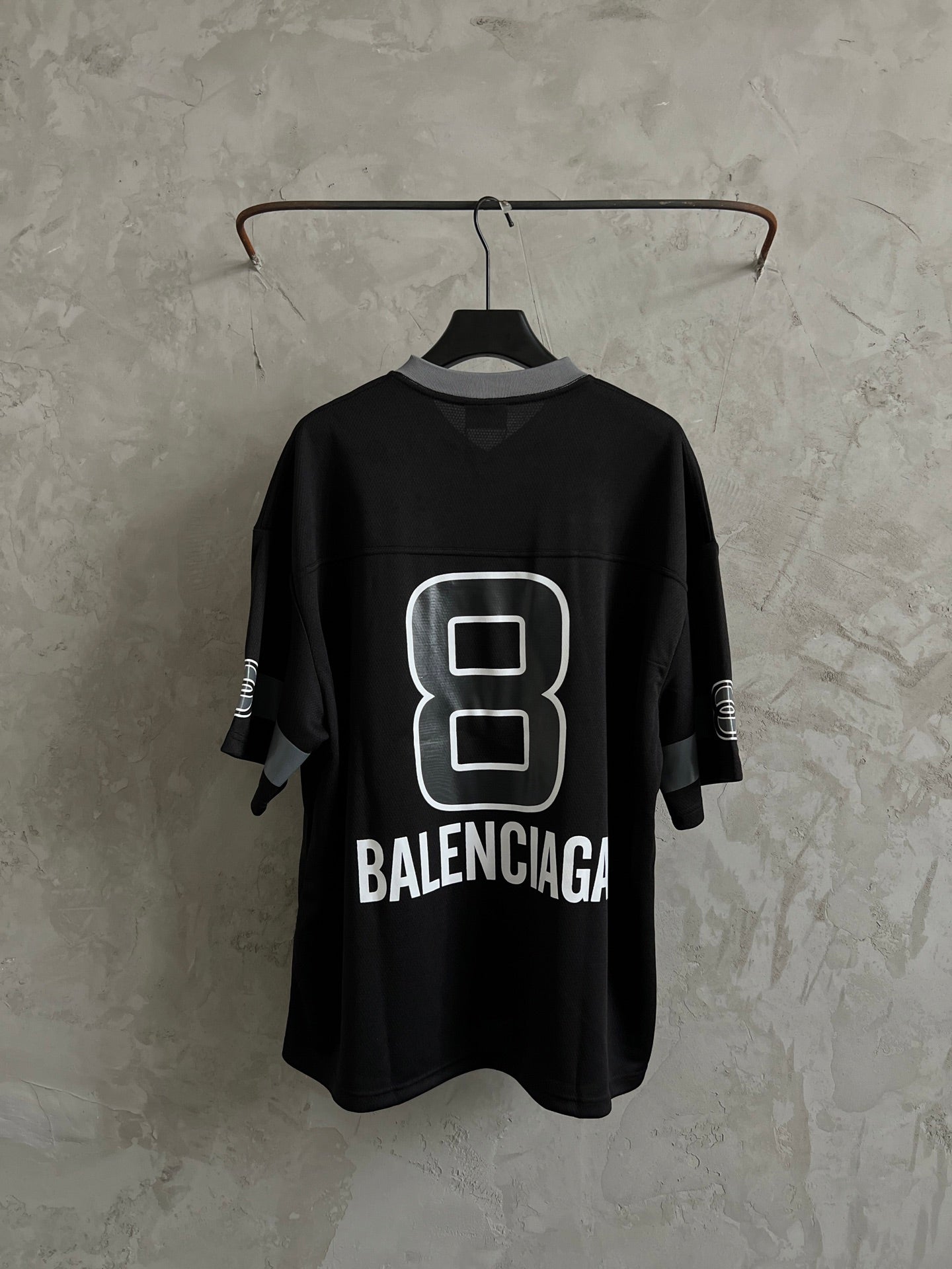 Balenciaga black short-sleeve T-shirt on hanger with white "8" logo