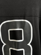 Balenciaga black T-shirt close-up of white "8" outline logo on chest