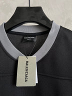 Balenciaga black T-shirt collar with Unisex label tag hanging from neckline