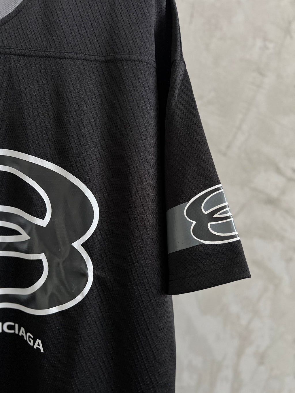 Balenciaga black short-sleeve T-shirt with white logo graphic on the sleeve