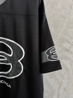 Balenciaga black short-sleeve T-shirt with white logo graphic on the sleeve