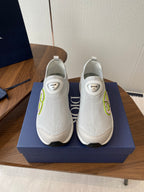 Unisex white slip-on sneakers with green logo detail and white rubber sole