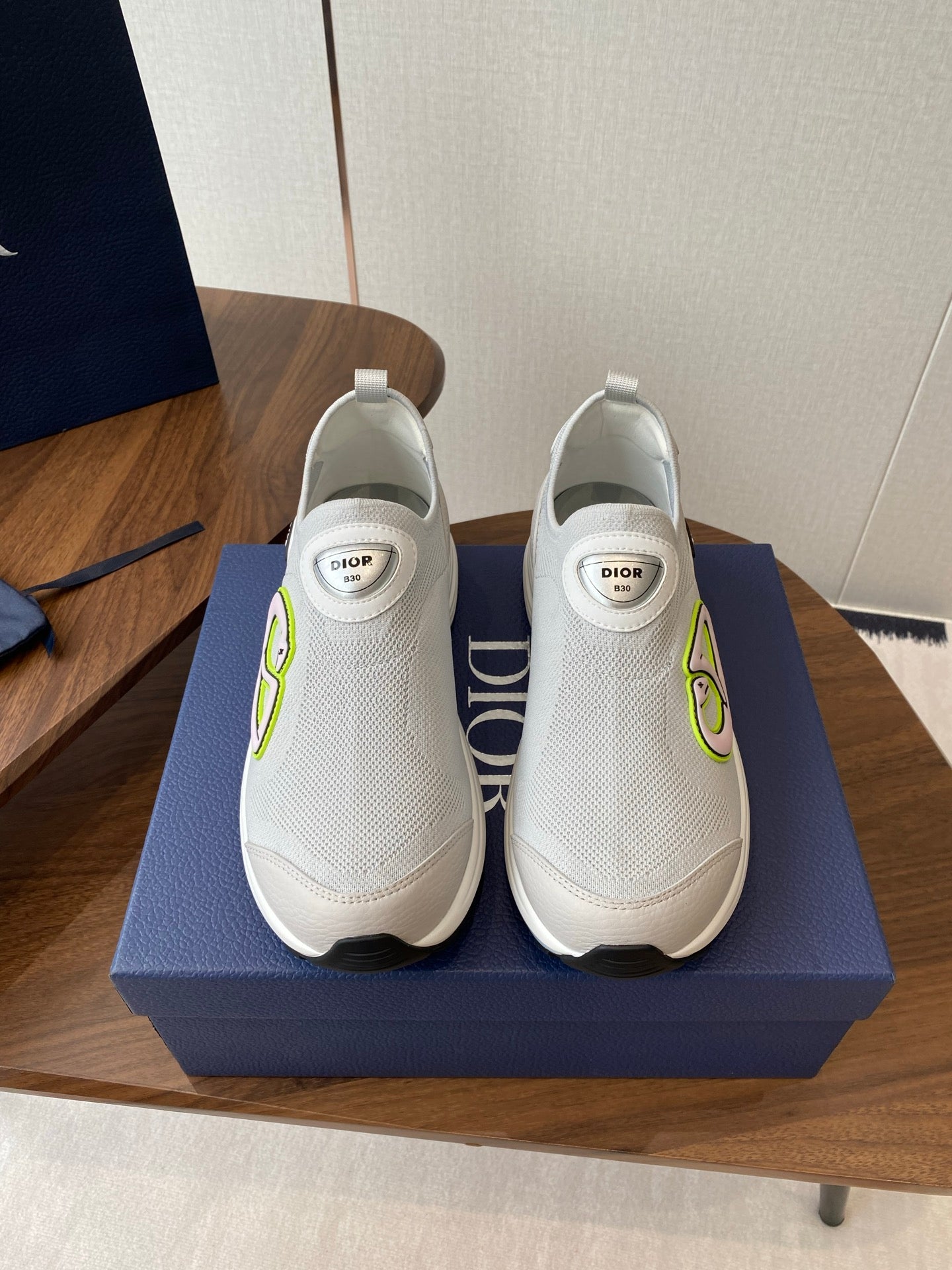 Unisex white slip-on sneakers with green logo detail and white rubber sole
