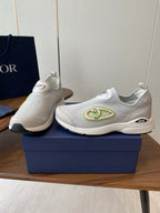Unisex white slip-on sneakers with green logo on side and DIOR badge on heel
