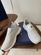 Unisex white slip-on sneakers with green logo, shown from side and top