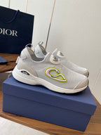 Unisex white slip-on sneakers on blue box, green logo accent on side