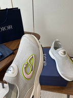 Unisex white slip-on sneaker with green logo on lateral side and DIOR tag