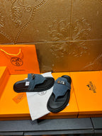 Hermes sandals with blue suede straps and silver buckle, pair shown on display