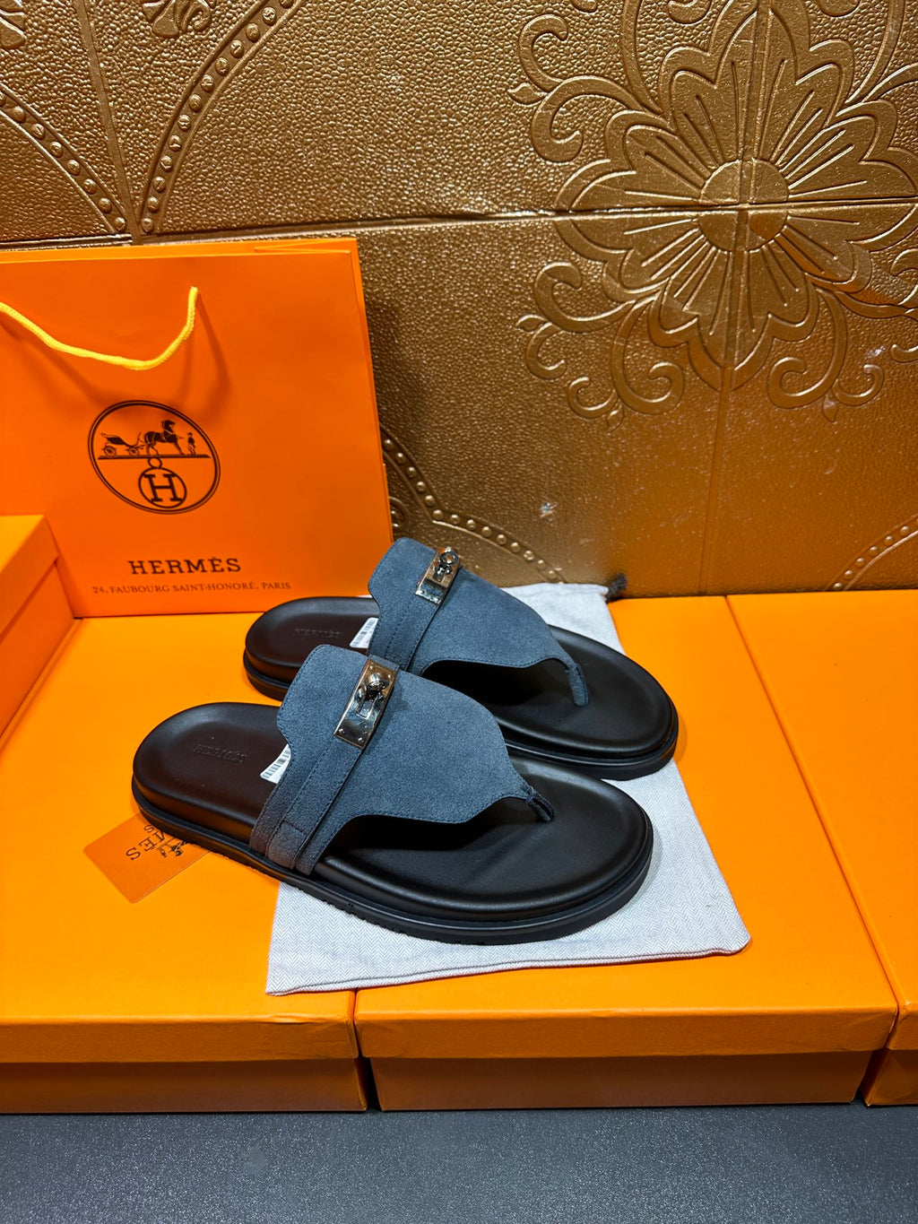 Hermes sandals featuring blue suede cross strap with silver buckle and black sole