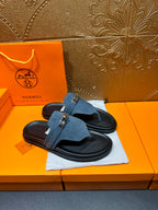 Hermes sandals featuring blue suede cross strap with silver buckle and black sole