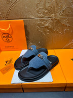 Hermes slide sandals in blue suede with a silver buckle strap and black footbeds