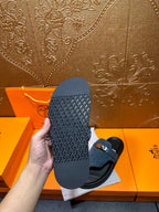 Hermes sandals, view of textured black outsole with blue upper and silver buckle