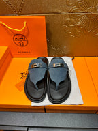 Hermes sandals with blue suede straps and silver buckle on black slide soles