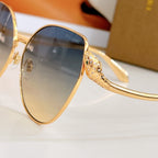 Bvlgari gold round sunglasses close-up with blue gradient lenses and embellished temple arm