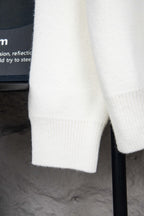 White ribbed knit cuffs on long-sleeve sweater