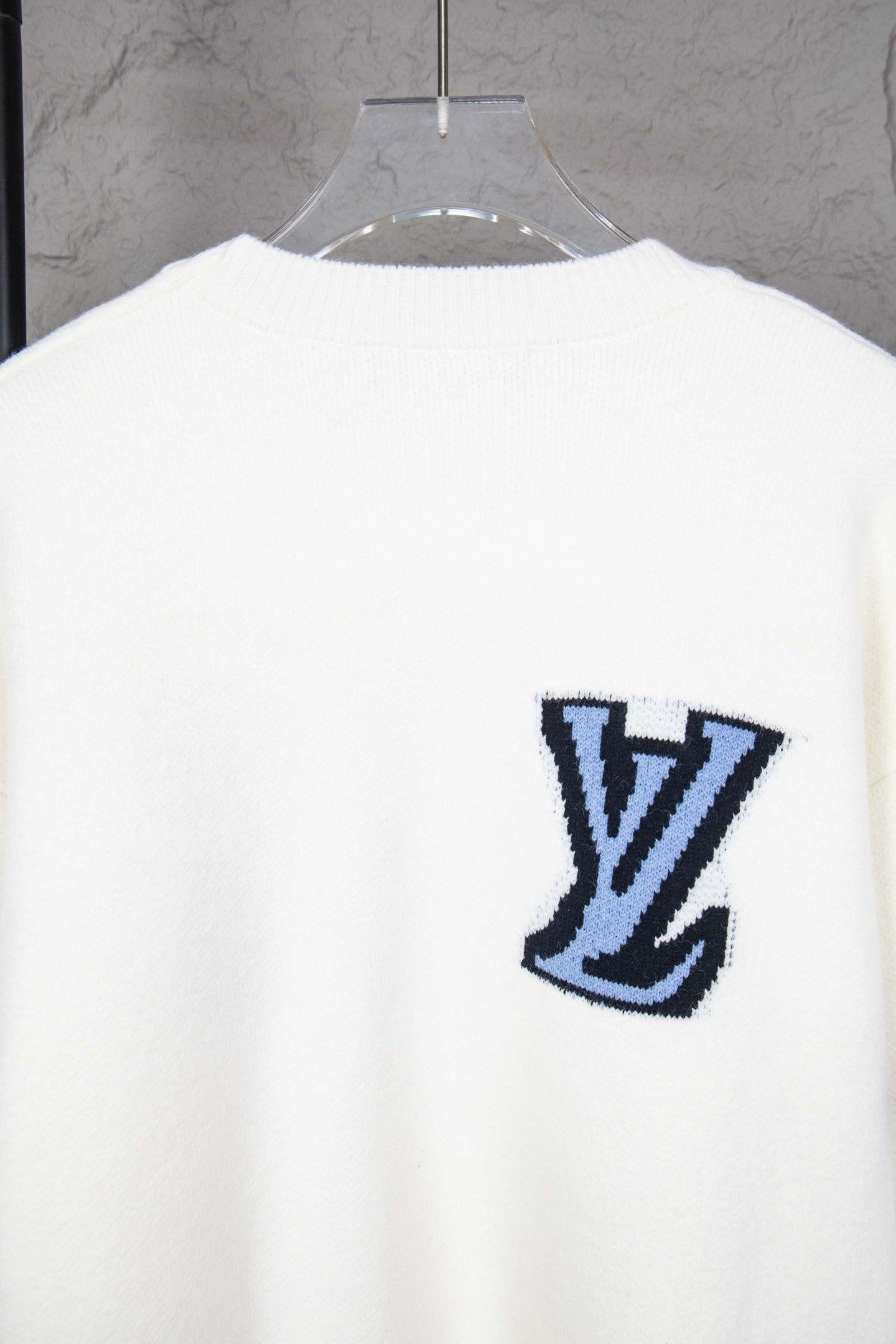 White knit sweater back with blue LV logo emblem