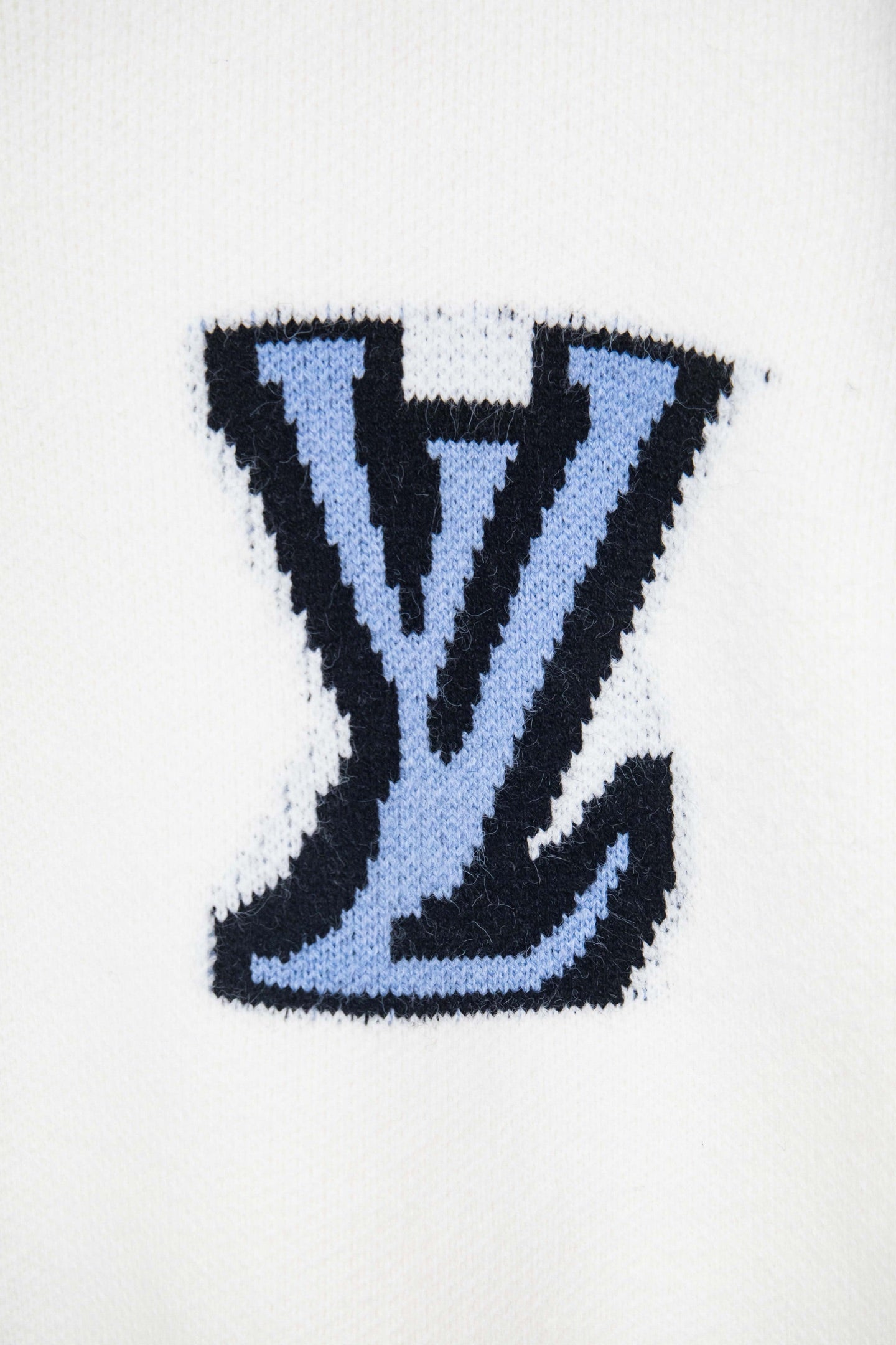 Blue LV monogram patch on white knit sweater