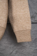 Beige knit sweater lower sleeve with ribbed hem trim