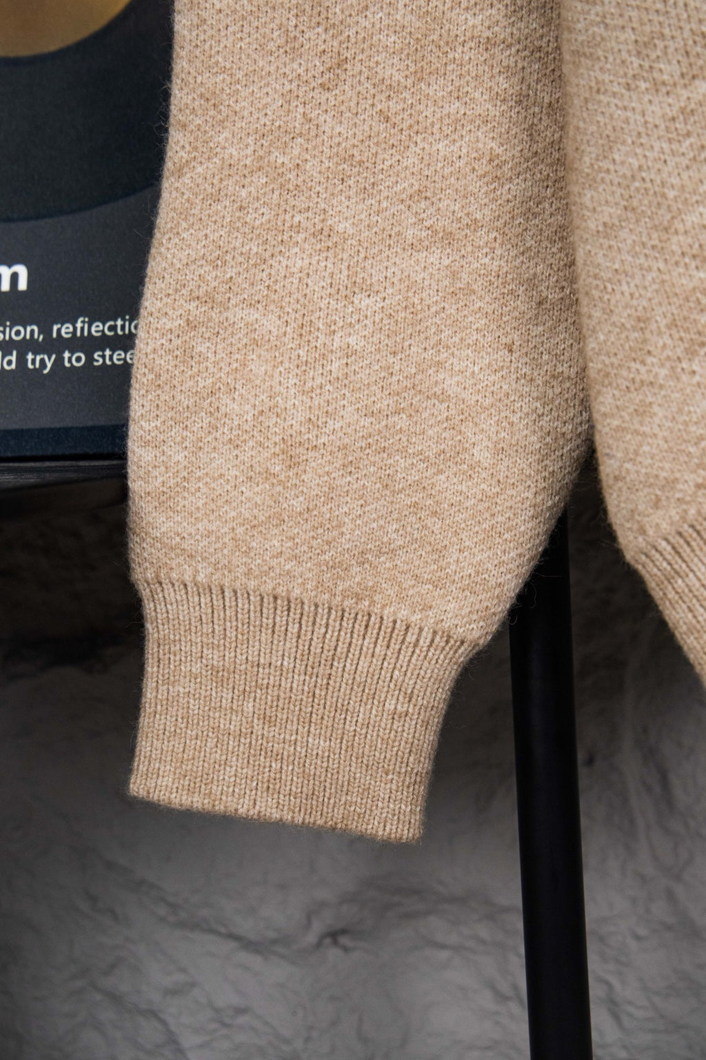 Beige knit sweater sleeve cuff with ribbed hem detail