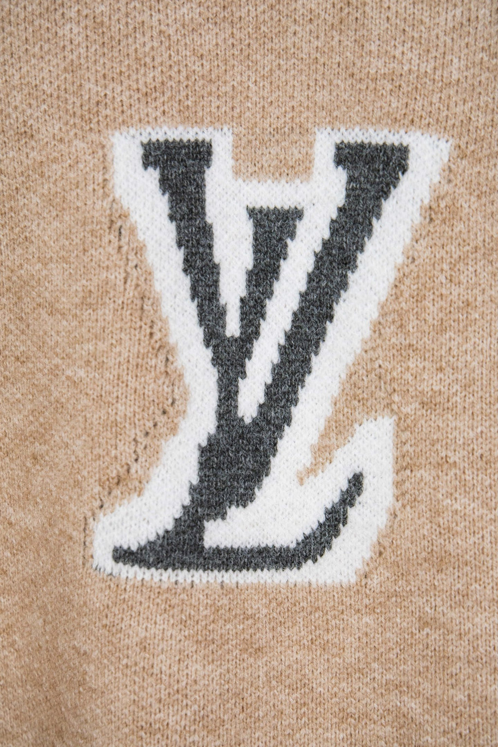 Beige knit sweater with large white LV monogram patch
