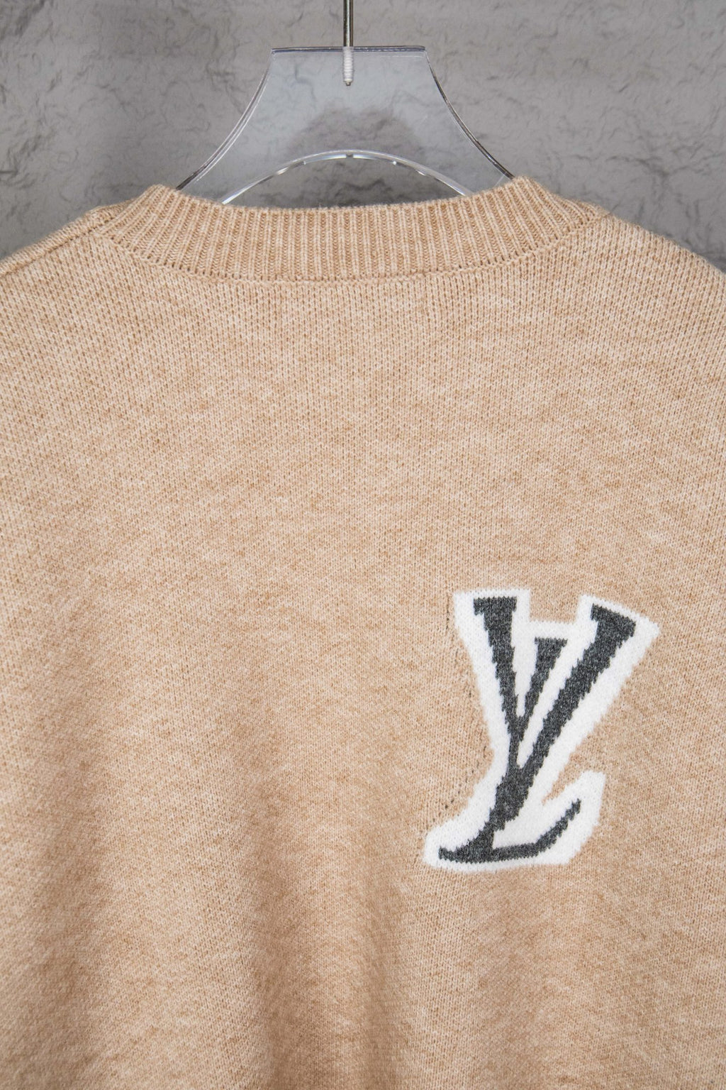Beige knit sweater back with small LV logo near the collar