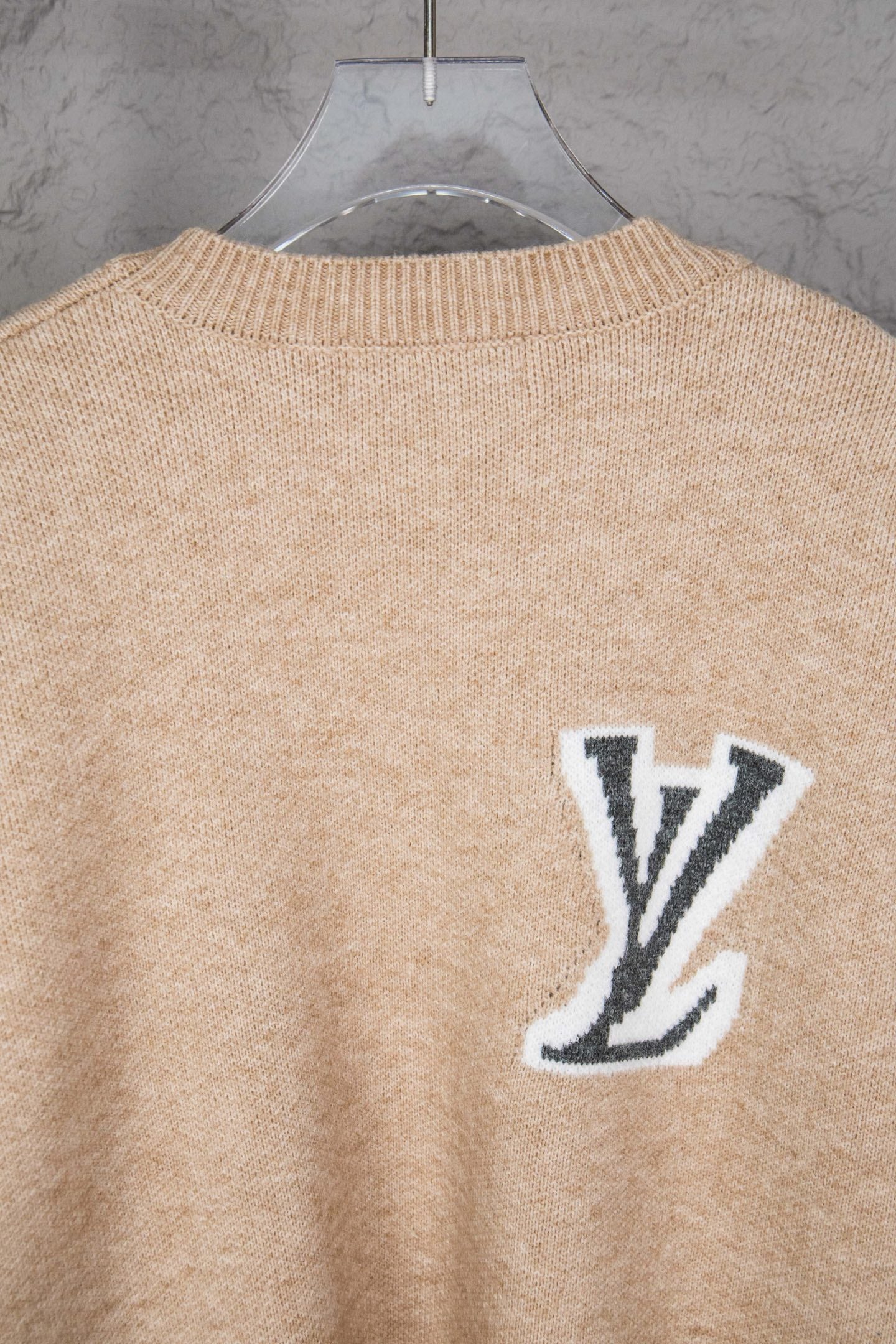 Beige knit sweater back with small LV logo near the collar