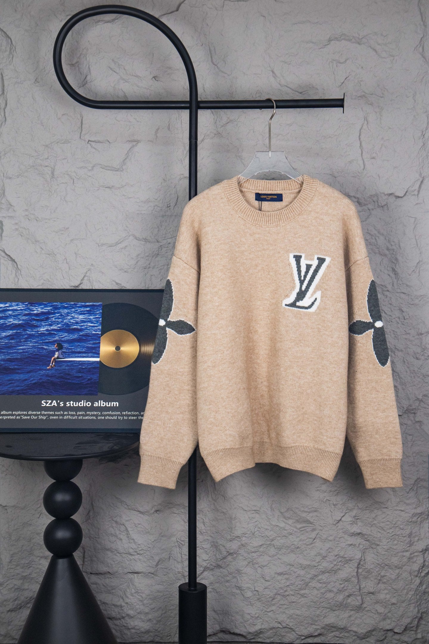 Beige knit sweater with large LV logo on front, crew neck, long sleeves