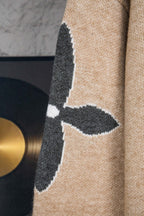 Beige knit sweater sleeve with dark vertical LV graphic