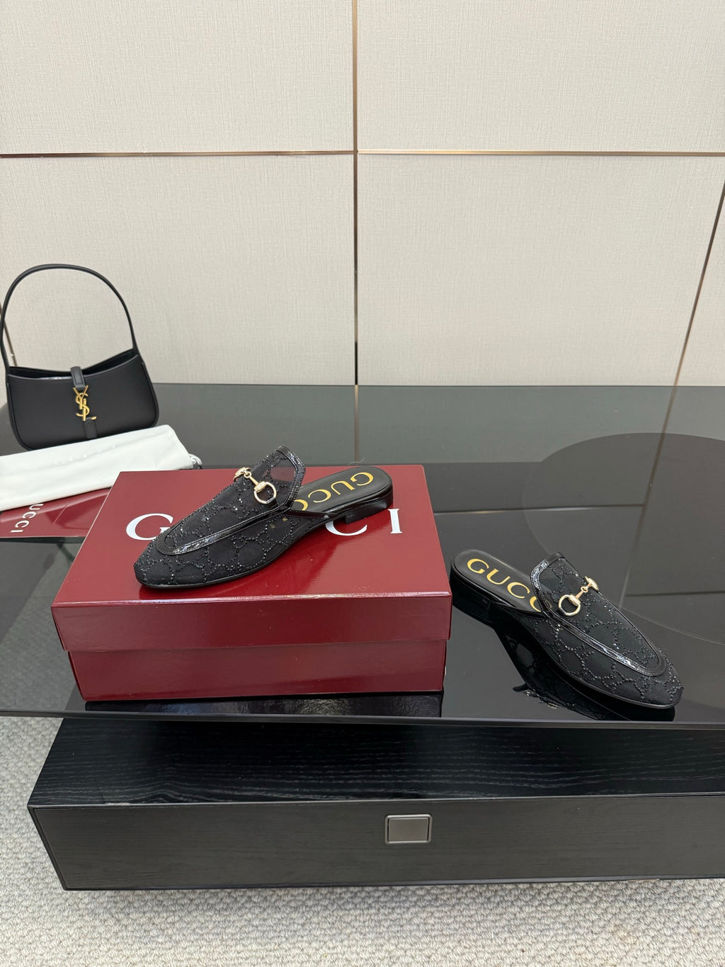 Gucci black horsebit mule with gold buckle detail, textured leather and curved heel