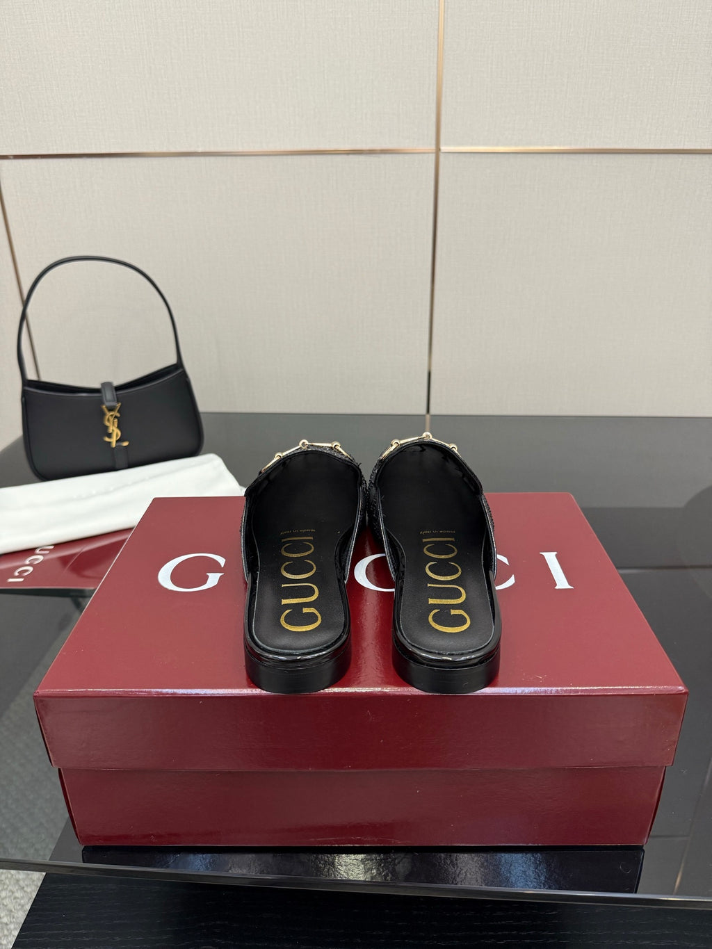 Gucci black slip-on mules with logo print on the heel and gold-toned hardware