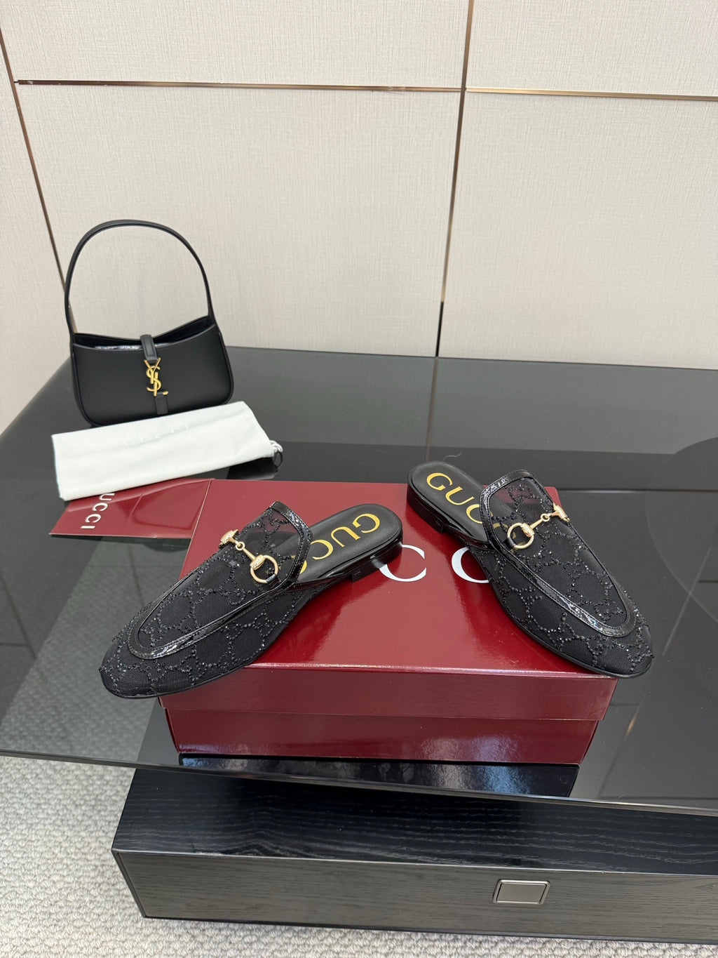 Gucci black horsebit mules, gold rings on the strap, textured leather upper