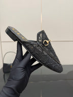 Gucci black horsebit mule with gold-tone ring bit and embossed leather pattern