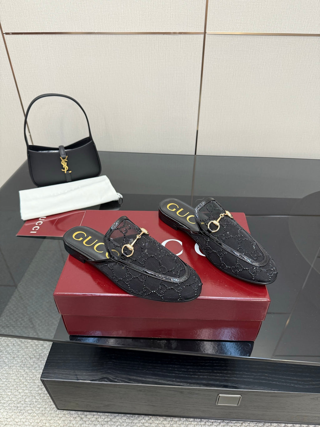 Gucci black horsebit loafers with gold buckle accents and textured embossed finish