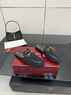 Gucci black horsebit loafers with gold buckle accents and textured embossed finish