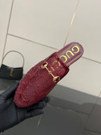 Gucci women's burgundy loafers with gold horsebit, close-up side view